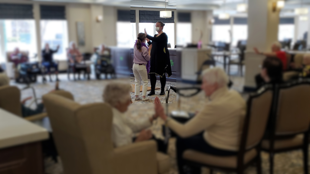 Gallery 25 Marjorie leading the clap dance at a seniors' home